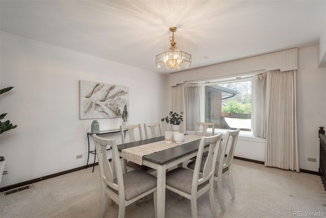 dining room with baseboards, light carpet, a notable chandelier, and visible vents