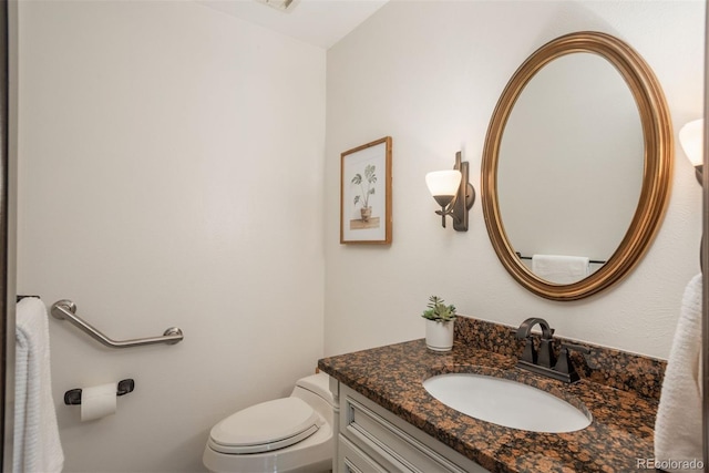 bathroom with toilet and vanity