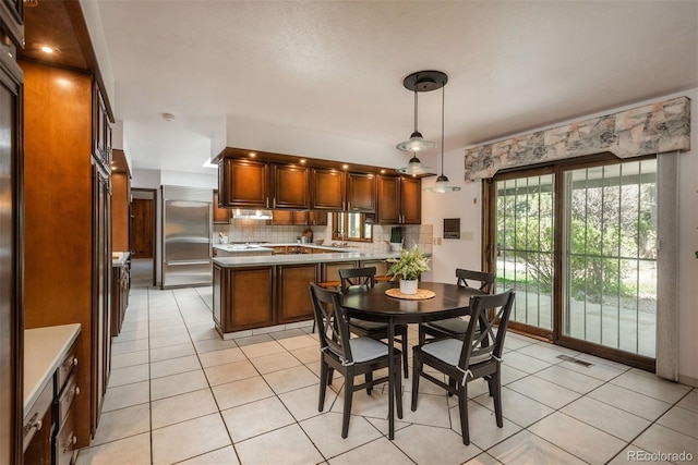 dining area featuring light tile patterned flooring and visible vents