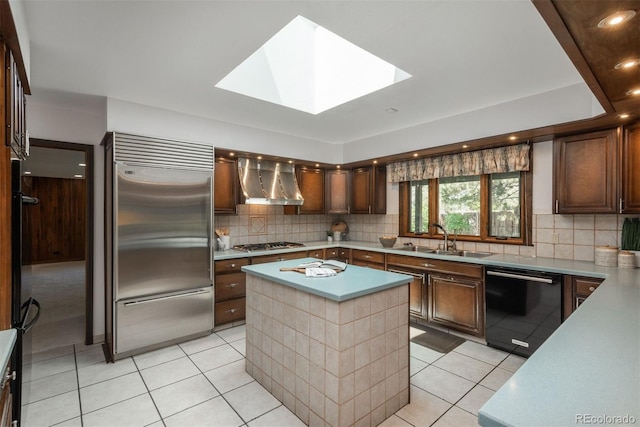 kitchen featuring a sink, light countertops, wall chimney exhaust hood, stainless steel appliances, and light tile patterned floors