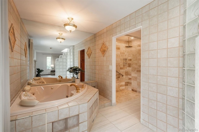 bathroom featuring a whirlpool tub, walk in shower, tile patterned floors, and tile walls