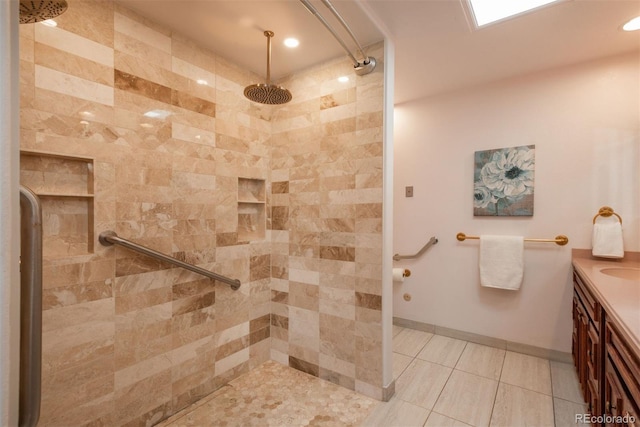 bathroom featuring vanity, recessed lighting, tile patterned flooring, and a tile shower