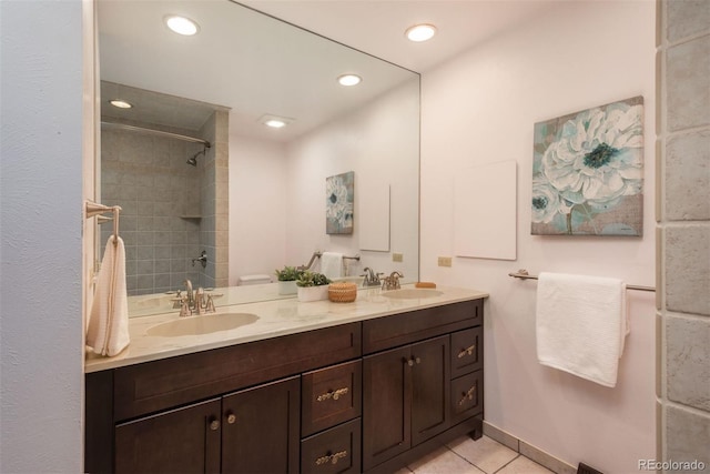 bathroom featuring double vanity, recessed lighting, tile patterned floors, and a sink