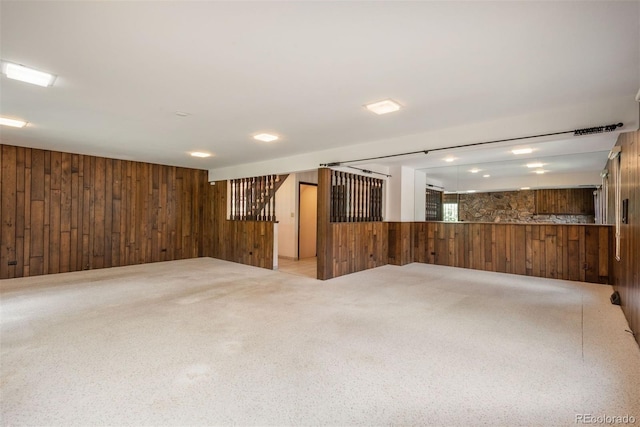 below grade area with carpet flooring and wood walls