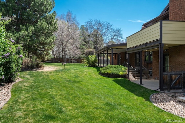 view of yard featuring a patio and fence