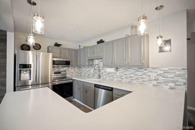 933 Straight Creek Dr Unit 101, Dillon, CO 80435 - kitchen featuring a sink, tasteful backsplash, light countertops, gray cabinetry, and appliances with stainless steel finishes