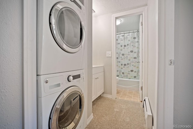 933 Straight Creek Dr Unit 101, Dillon, CO 80435 - laundry area with stacked washer / drying machine, laundry area, baseboards, a baseboard heating unit, and light colored carpet