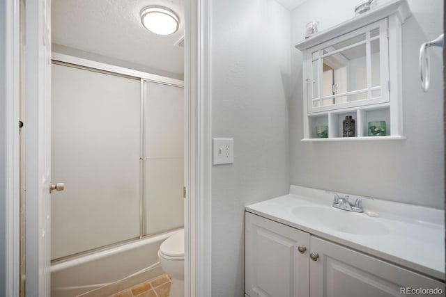 933 Straight Creek Dr Unit 101, Dillon, CO 80435 - bathroom featuring toilet, vanity, and enclosed tub / shower combo
