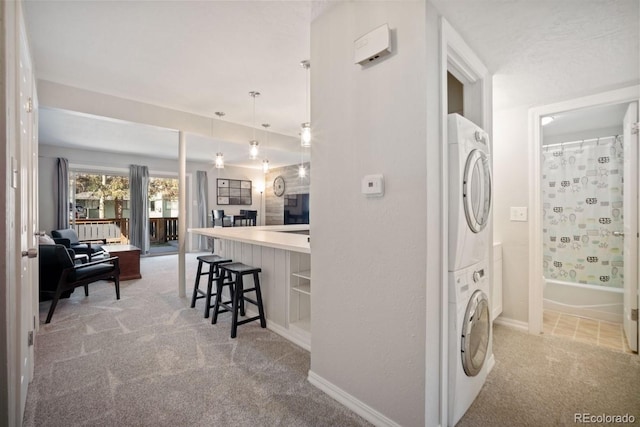 933 Straight Creek Dr Unit 101, Dillon, CO 80435 - laundry area with laundry area, baseboards, stacked washer / drying machine, and carpet floors