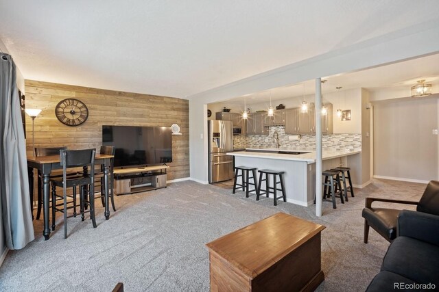 933 Straight Creek Dr Unit 101, Dillon, CO 80435 - living area featuring wooden walls, baseboards, and light carpet