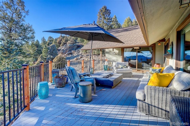 wooden deck with an outdoor living space with a fire pit