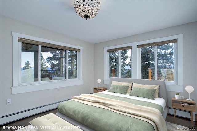 bedroom with baseboard heating and dark wood-type flooring