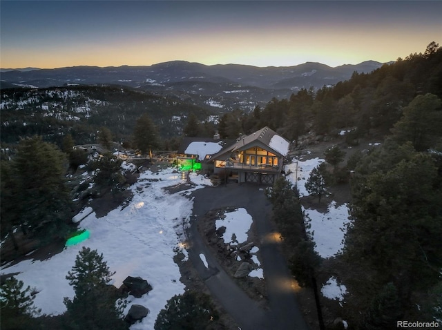 snowy aerial view featuring a mountain view