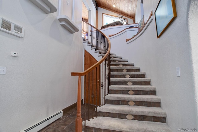 stairs featuring tile patterned floors, vaulted ceiling, and baseboard heating