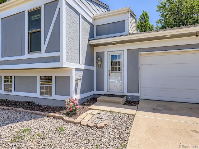 1956 Cathay St, Aurora, CO 80011 - property entrance with stucco siding, a garage, and concrete driveway