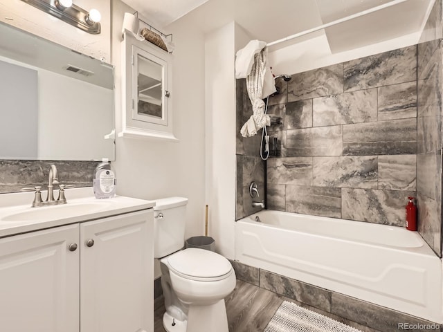 1956 Cathay St, Aurora, CO 80011 - full bath with shower / bathtub combination, vanity, and wood finished floors