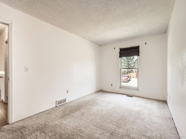 1956 Cathay St, Aurora, CO 80011 - spare room with carpet floors and a textured ceiling