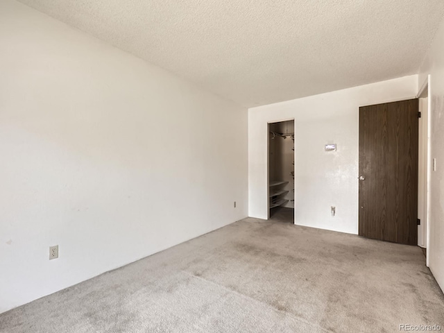 1956 Cathay St, Aurora, CO 80011 - spare room with carpet and a textured ceiling
