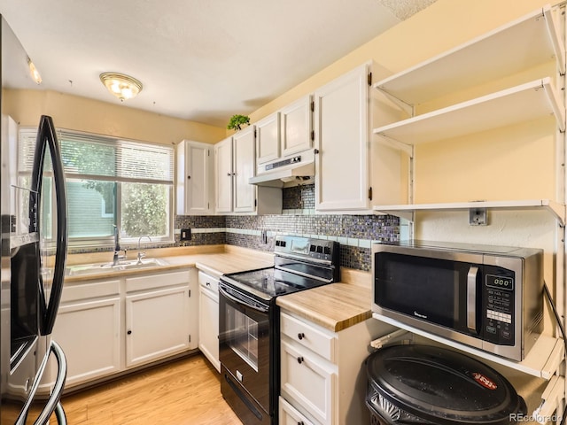 1956 Cathay St, Aurora, CO 80011 - kitchen featuring black appliances, under cabinet range hood, light countertops, and white cabinets