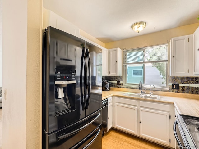 1956 Cathay St, Aurora, CO 80011 - kitchen with black fridge with ice dispenser, range, decorative backsplash, and white cabinets