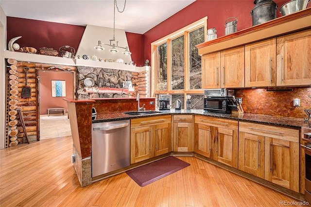 kitchen with stainless steel dishwasher, light hardwood / wood-style flooring, hanging light fixtures, log walls, and sink