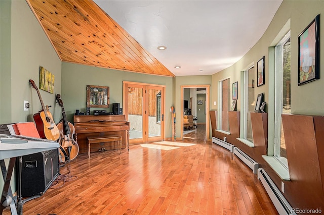 interior space with wooden ceiling, a baseboard radiator, and wood-type flooring