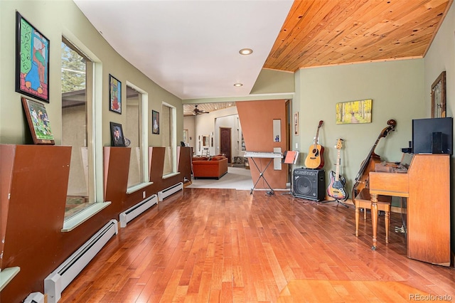 hallway with wooden ceiling, a baseboard radiator, and light hardwood / wood-style flooring