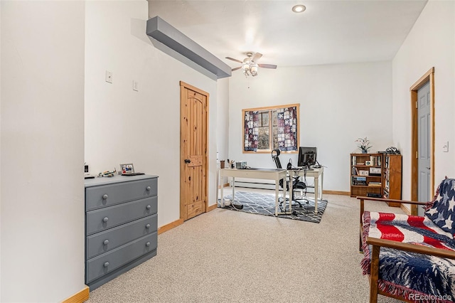 carpeted office space with lofted ceiling and ceiling fan