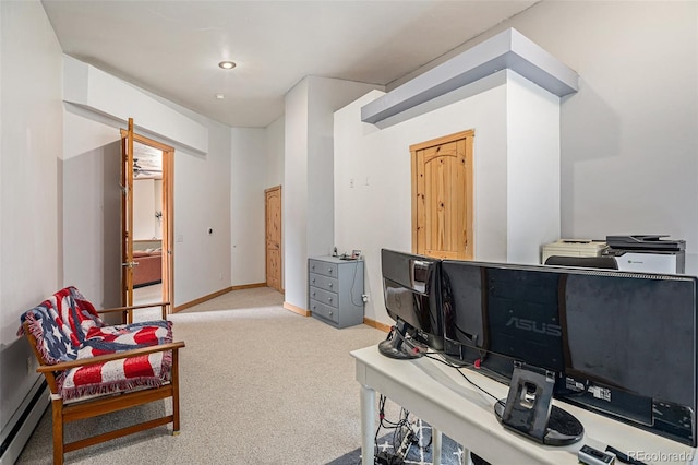 office space with carpet and a baseboard heating unit