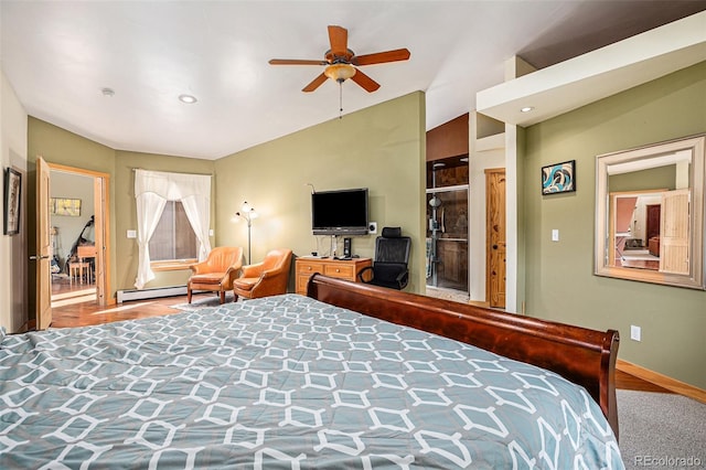 bedroom featuring vaulted ceiling, a baseboard heating unit, and ceiling fan