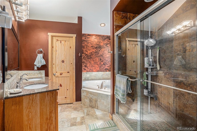 bathroom featuring shower with separate bathtub and vanity