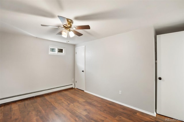 spare room featuring baseboard heating, dark wood-type flooring, and ceiling fan