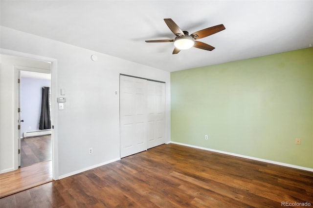 unfurnished bedroom with ceiling fan, a closet, dark wood-type flooring, and a baseboard radiator