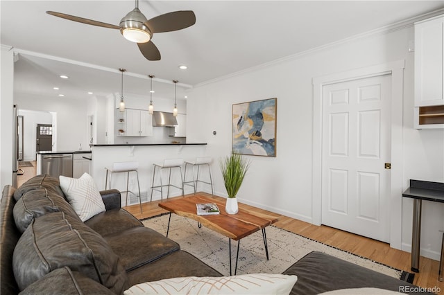 living area with baseboards, recessed lighting, a ceiling fan, and light wood-style floors