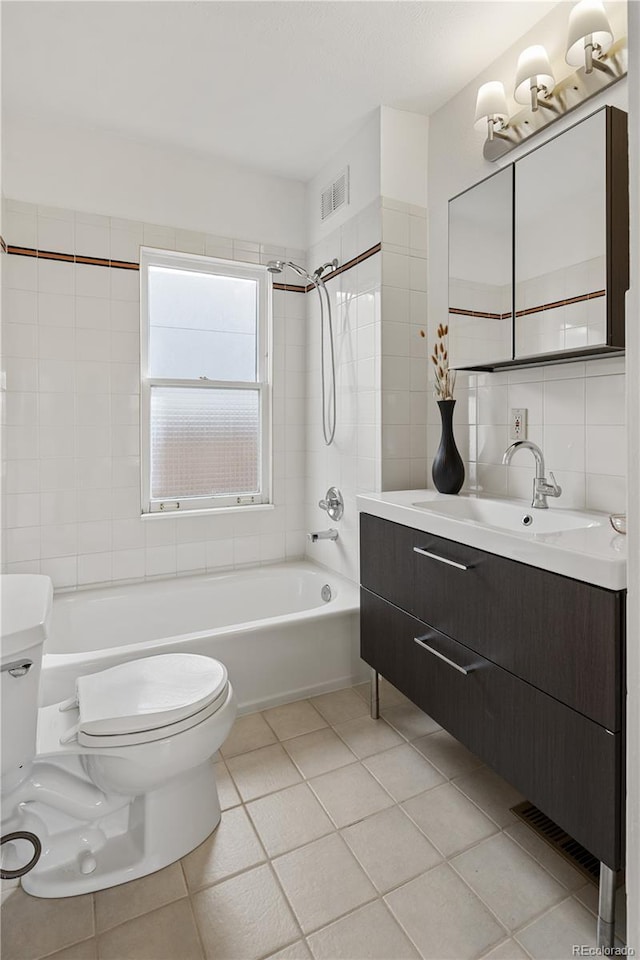 bathroom featuring visible vents, toilet, tile walls,  shower combination, and tile patterned flooring