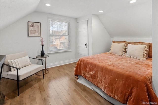 bedroom with recessed lighting, baseboards, lofted ceiling, and hardwood / wood-style flooring