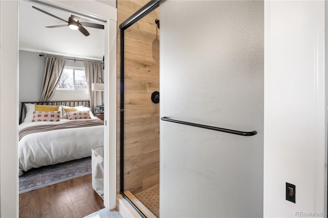 ensuite bathroom with a ceiling fan, ensuite bath, a shower stall, and hardwood / wood-style flooring