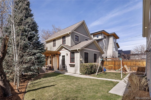 view of front of house with entry steps, a pergola, fence, a front yard, and a shingled roof