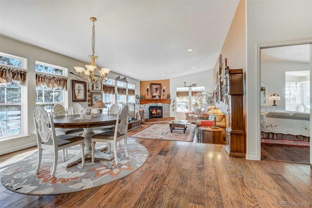 dining area with hardwood / wood-style floors and a chandelier