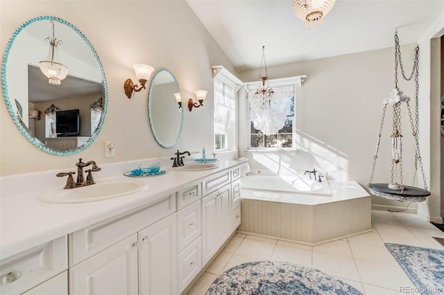 bathroom with tile patterned flooring, tiled bath, and dual vanity