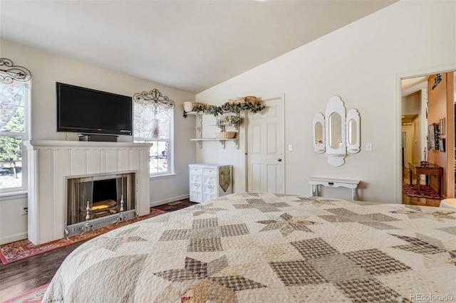 bedroom with hardwood / wood-style flooring and vaulted ceiling