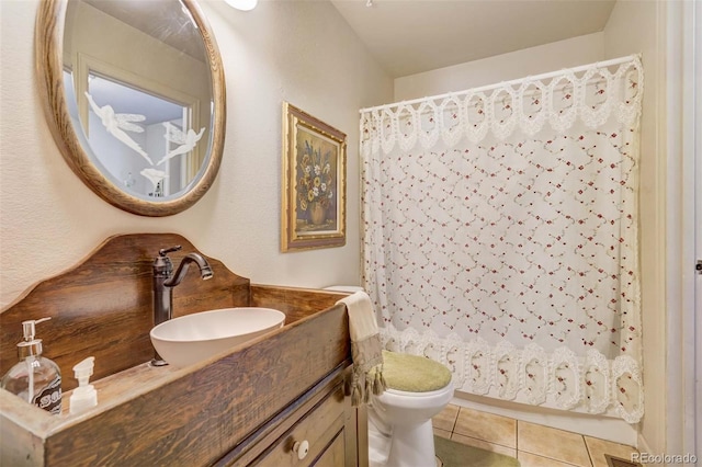 bathroom featuring vanity, toilet, and tile patterned flooring