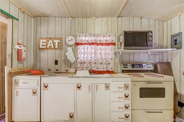 kitchen featuring white range with electric stovetop and wooden walls