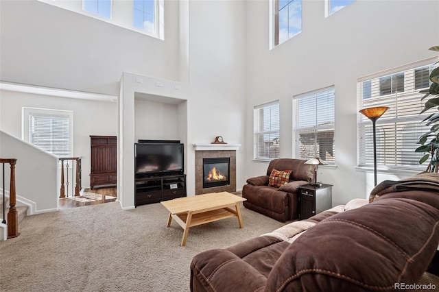 carpeted living room with a fireplace and visible vents