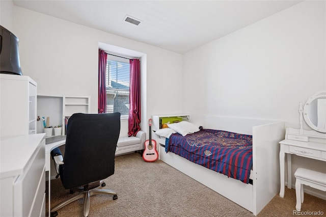 carpeted bedroom featuring visible vents