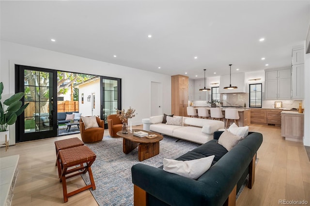 living room with light hardwood / wood-style floors and french doors