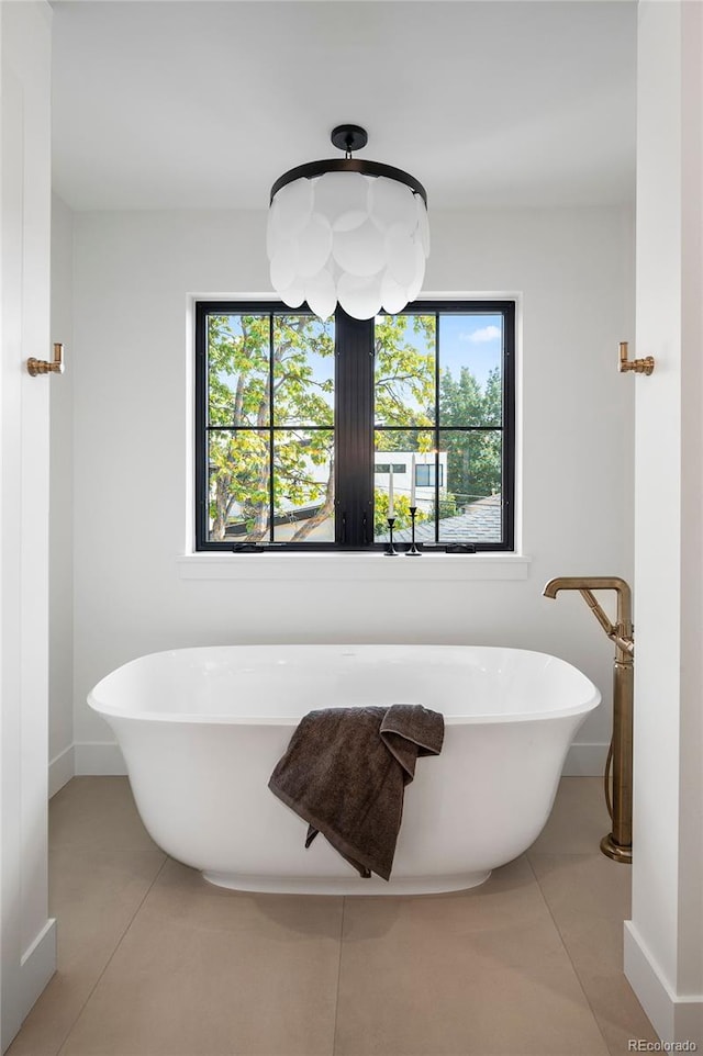 bathroom featuring tile patterned flooring and a bath