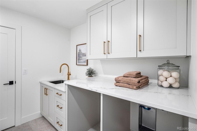 clothes washing area featuring sink