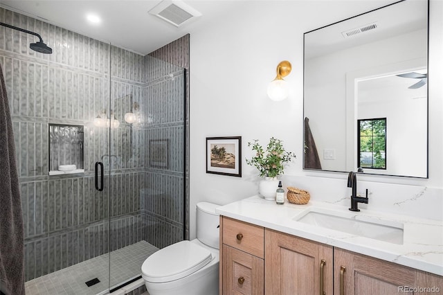 bathroom with vanity, toilet, and an enclosed shower