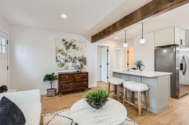 1120 Xenia St, Denver, CO 80220 - living area with beam ceiling, light wood-style flooring, recessed lighting, and baseboards